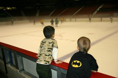 Edward and Michael watch from the penalty box as the kids play hockey (there is no glass, just the thick fog above the ice).