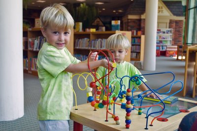 Brothers Thomas and Steven playing at the library