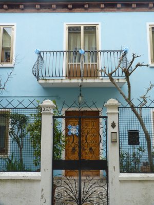 Front door to a residence with blue ribbon decorations