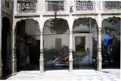 The courtyard of carved marble arches was being used as storage space/barn