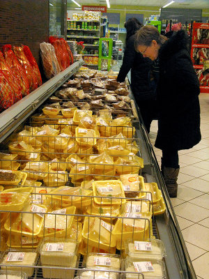 Margaret is checking out the cheese section .. 7139