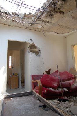 Kiryat Shmona.  Town hit with over 1000 katyusha rockets. Direct hit to a living room. No one home at the time, luckily.