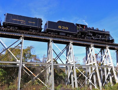 NS Roadforeman  J. Brantley gives a friendly wave as 630 eases over the former TC bridge at Harriman 