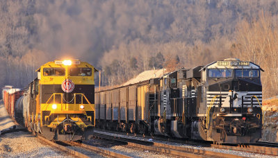 The sun is setting fast as 117 passes a grain train tied down in the yard at General 