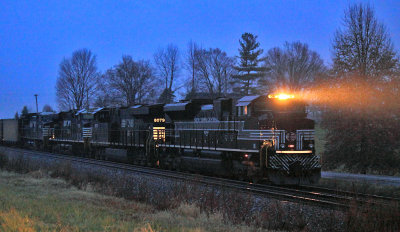 The rain is coming down hard as NYC 1066 leads an empty coal train through the siding at Waddy 