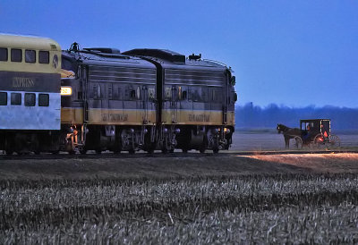 An Amish family pauses to watch the KJRY pass by at dusk