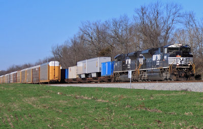 Southbound 229 has a pair of EMD's leading as they pass the bottom of 276 at Leathers field near McKinney 