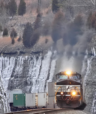 Train 229 flies up Kings Mountain, surrounded by ice in the cut 