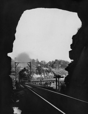 A Northbound engine is crossing the river and is about to enter tunnel #4 in this vintage view 