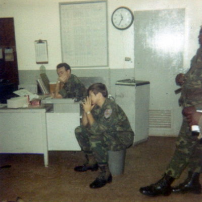 04 - K. C. Szmall sitting at desk, far left.