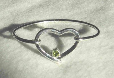 The heart is approx 3cm at the widest point, with a 5mm faceted peridot. The heart is also part of the hinged clasp. SOLD