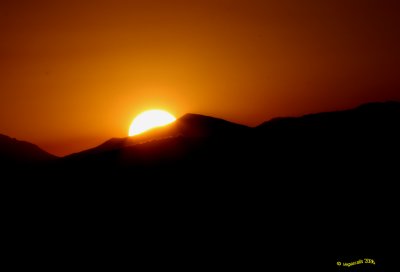 Sunrise behind Morman Mesa.