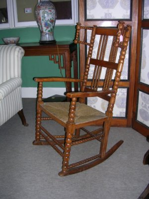 Adam's rocking chair in the antique shop