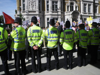 Standing Behind the Row of Policemen
