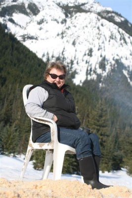 Cook Enjoying Warm Winter Sun After Mushers Leave Checkpoint