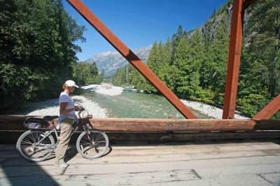 Biker Enjoying View Of Stehekin River And Looking For Spawning Fish