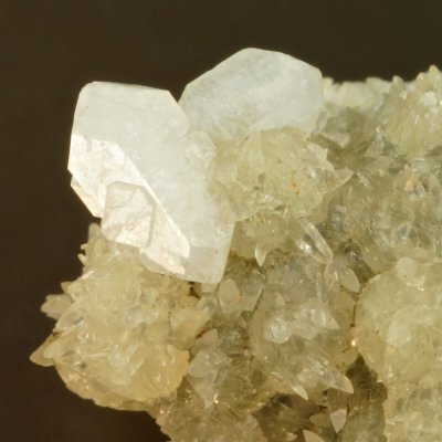 Phillipsite, 18 mm specimen with twins to 6 mm on a druse of calcite. Alter Stein quarry, Allendorf, Umtal, Westerwald, Hessen