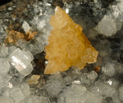 Phillipsite, 4 cm specimen with a druse of sparkling crystals decorated by a 9 mm spray of orange calcite crystals. Alter Stein 