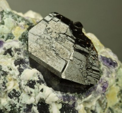 Cassiterite, glossy sharp 38 mm twinned crystal group. Mian Yan, Sechuan, China.