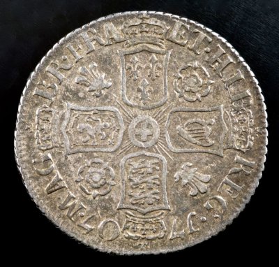 1707 sixpence made of English silver. Roses and plumes in the angles indicate the Northern England source of the silver.