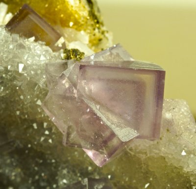 Fluorite colour-zoned interpenetrant twins to 2 cm on 10 cm drusy quartz matrix, Cambokeels Mine.