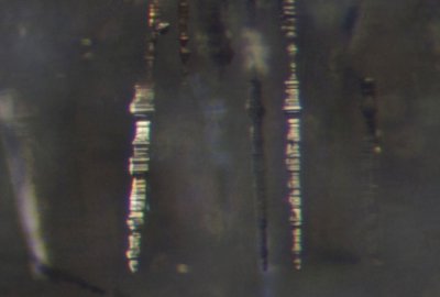 Pyrite inclusions Raygill, FOV a little less than 2 mm. Note the comparable microstratigraphies of widening and narrowing.