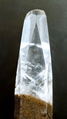 Transparent colourless calcite crystal (40 mm) showing steep scalenohedral faces, Egremont, Cumbria. 19th Century specimen.