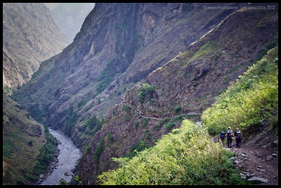 Trekkers and mules on the trail along the Budhi Gandaki