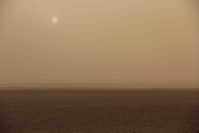 Sun peeking through a sandstorm in the Sahara, near Merzouga.