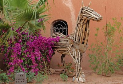 Wooden horse and bougainvillea.