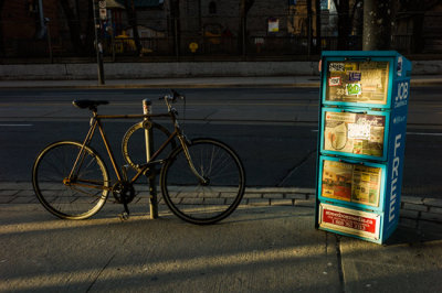 Bicycle and Free Newspapers in the Late Afternoon