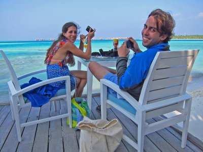 Photographers on Vilu deck with two cameras and a tube of Pringles