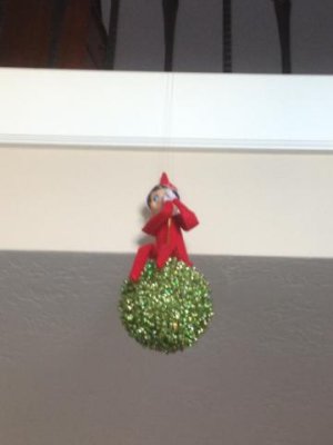 our elf got creative this year- hanging on the kissing ball