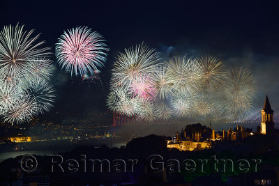 Light show on the Bosphorus Bridge with fireworks and night lights on Topkapi Palace Istanbul