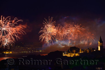 Republic Day fireworks over the Boshporus with lit Topkapi and Dolmabahce Palaces Istanbul Turkey