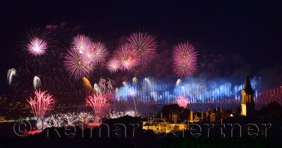 Light show on the Bosphorus Bridge with fireworks and night lights on Topkapi Palace Istanbul