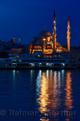 The New Mosque with Nuruosmaniye at twilight early morning with lights reflected in the Golden Horn Istanbul