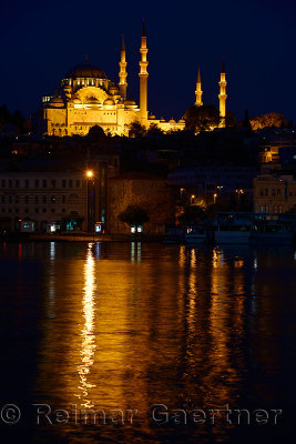 Lights of Suleymaniye Mosque largest in Istanbul reflected before dawn in waters of the Golden Horn