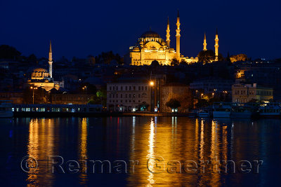 Rustem Pasha and Suleymaniye Mosques in Istanbul reflected before dawn in waters of the Golden Horn