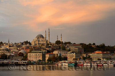 Rustem Pasha and Suleymaniye Mosques with golden sunrise on the waters of the Golden Horn Istanbul