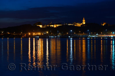 Topkapi Palace at early morning twilight with lights reflected in the Golden Horn Istanbul