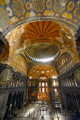 Golden domes frescoe and crooked Qiblah wall inside the Hagia Sophia with wood pendants