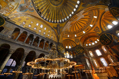 Golden ceiling domes and lit chandeliers in the Hagia Sophia Istanbul