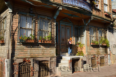 Woman standing at the door of a Historic Ottoman wooden house in Istanbul Turkey