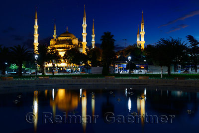 Blue Mosque lit at dusk with reflection in fountain Istanbul Turkey