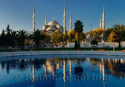Blue Mosque in early morning sun with reflection in fountain Istanbul Turkey