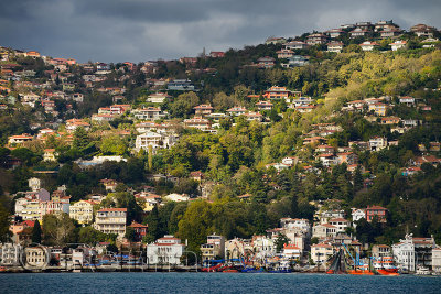 Sun on the hillside of Buyukdere Turkey with Seine fishing boats on the Bosphorus Strait