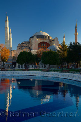 Early morning sun on the Hagia Sophia with reflection in fountain Istanbul Turkey