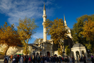 Crowd following green casket in funeral procession at Eyup Sultan Mosque Istanbul Turkey