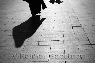 Shadow of a Muslem woman and two men walking on Eyup Sultan Boulevard Istanbul Turkey